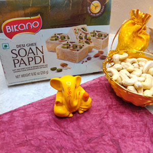 Bikano Soan Papdi with bright yello ganpati idol and cashews : Send Diwali Gifts to Australia Online