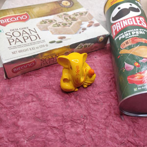 San papdi with peri peri pringles and Yellow ganesha idol