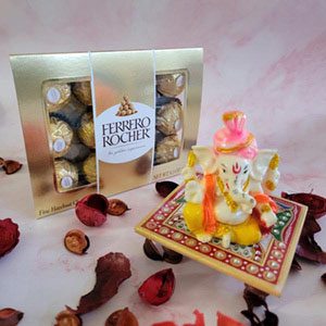 yellow and white ganpati idol with ferrero rochers