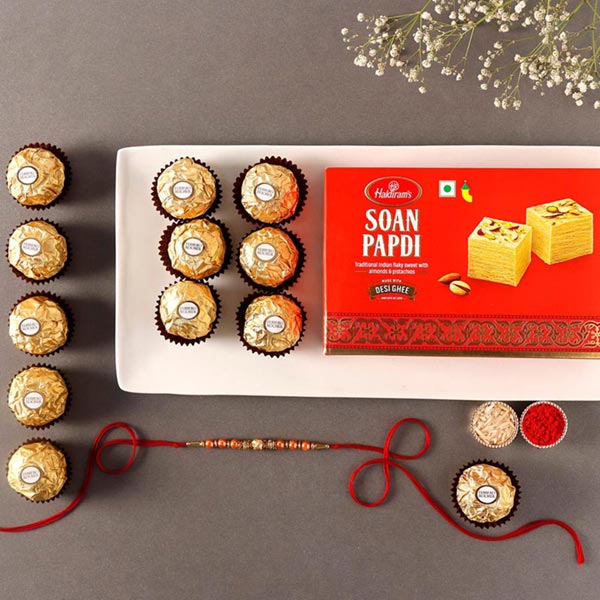 Send Sneh Rose Gold Rakhi With Soan Papdi & Ferrero Rocher Online