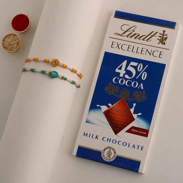 Send Sneh Vibrant Set Of 2 Pearl Rakhis & Lindt Bar Online