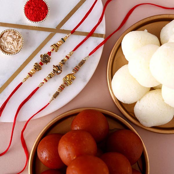 Send Sneh Feng Shui Rakhis & Sweets Tin to Qatar Online
