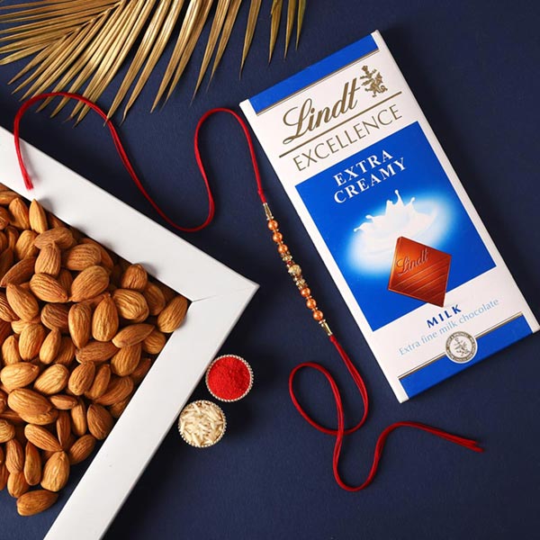 Send Sneh Sleek Rakhi With Lindt Chocolates & Almonds Online