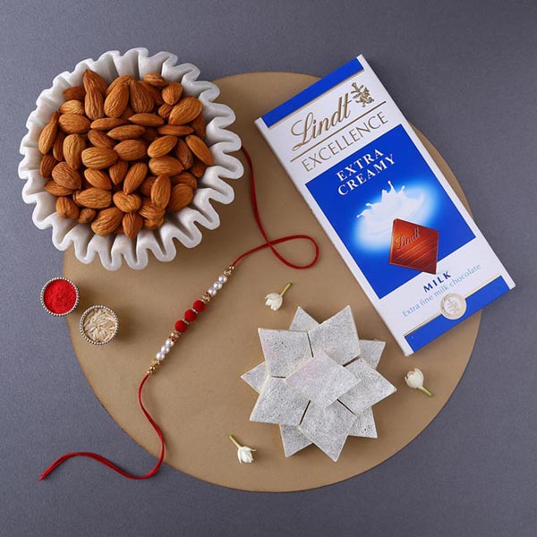 Send Sneh White Pearls Rakhi With Sweet Treats Online
