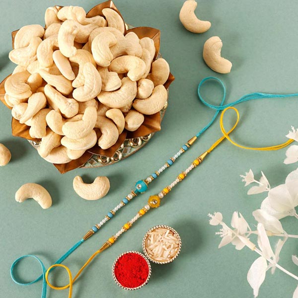 Send Sneh Vibrant Set Of 2 Pearl Rakhi & Cashews Online