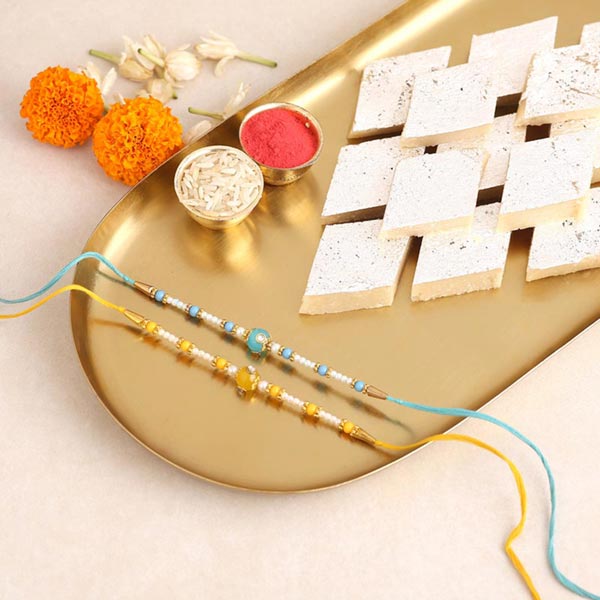 Send Sneh Vibrant Set Of 2 Pearl Rakhis & Kaju Katli Online