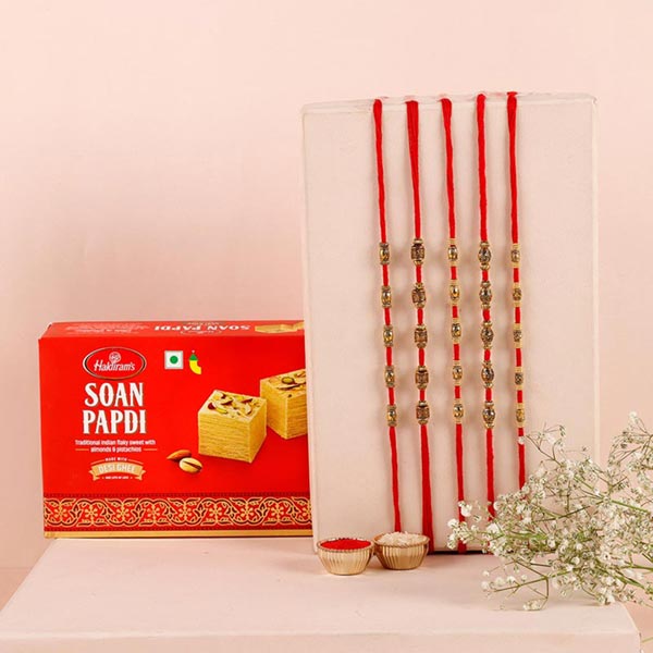 Send Sneh Brass Rakhi Set & Soan Papdi Online