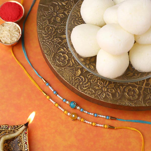 Send Sneh Vibrant Set Of 2 Pearl Rakhis & Rasgullas Online