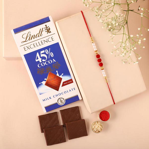 Send Sneh White Pearl Rakhi & Lindt Bar Online